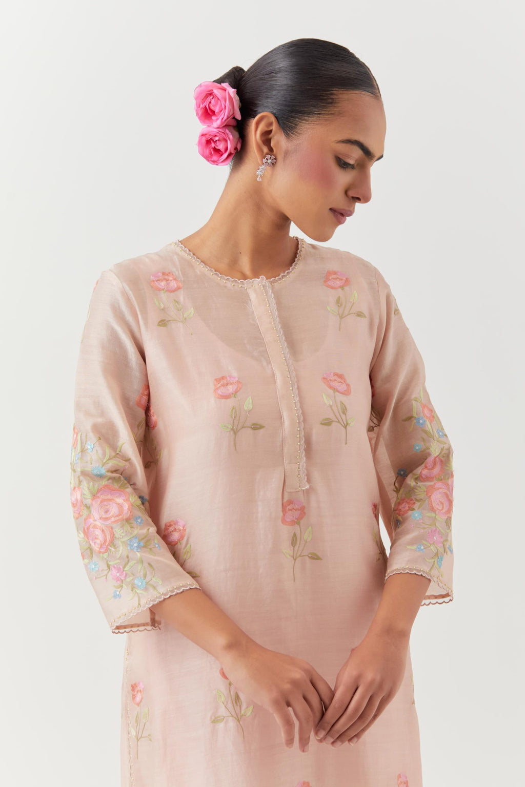 Pink silk Chanderi straight kurta set with all-over roses embroidered in thread and scalloped organza detail at the edges.