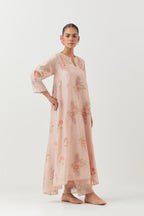 Pink silk chanderi easy fit, asymmetric hem, paneled kurta set with all-over thread embroidered roses, highlighted with scalloped organza at the edges with contrast beads.