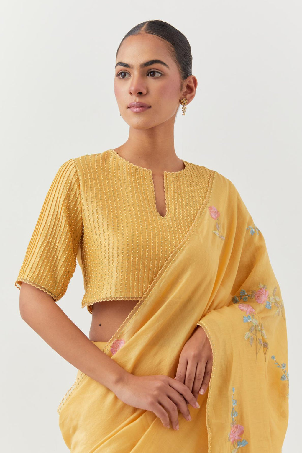 Yellow silk chanderi blouse with pin tucks, highlighted with bead work.