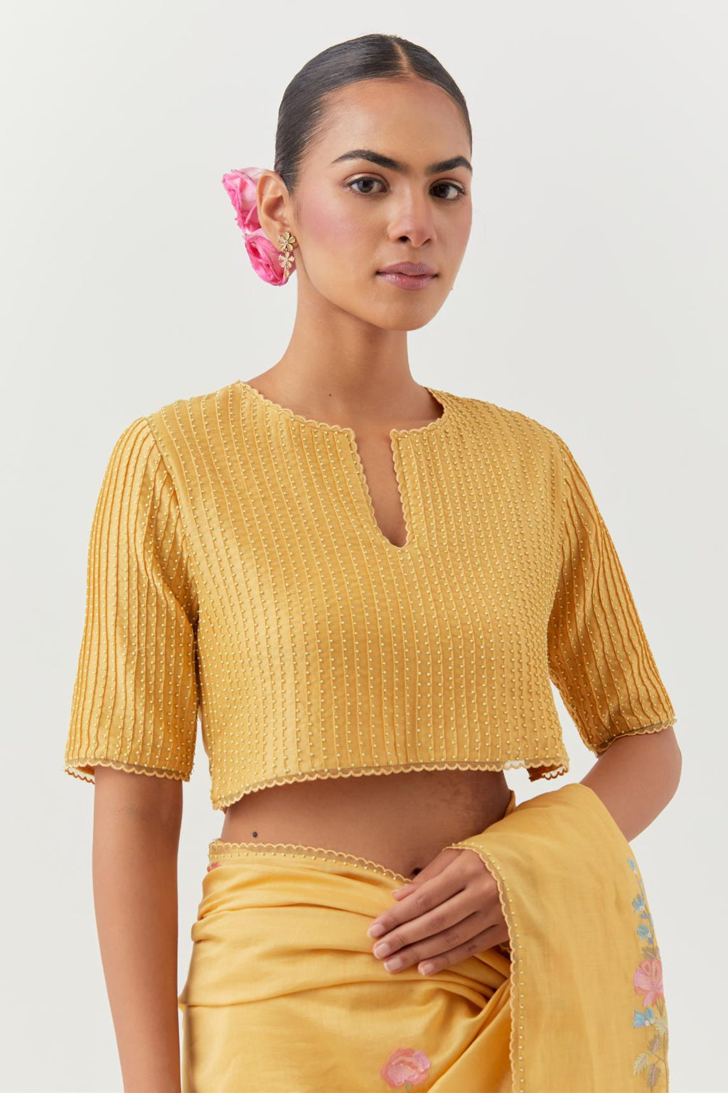 Yellow silk chanderi blouse with pin tucks, highlighted with bead work.