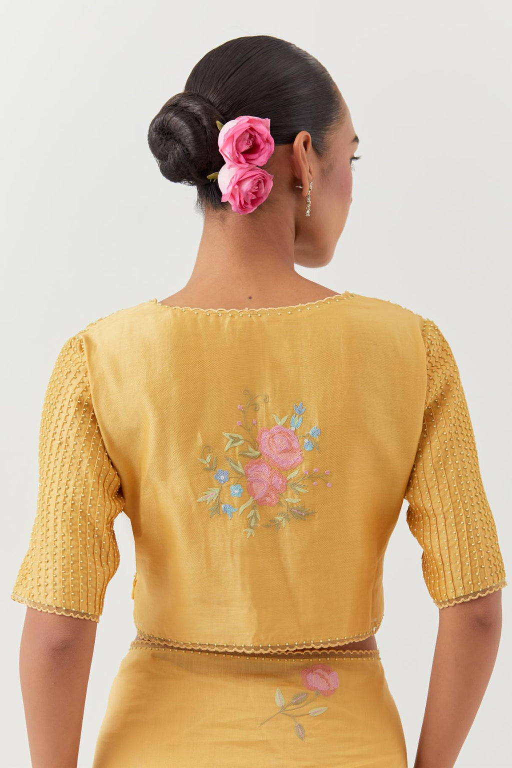 Yellow silk chanderi blouse with pin tucks, highlighted with bead work.