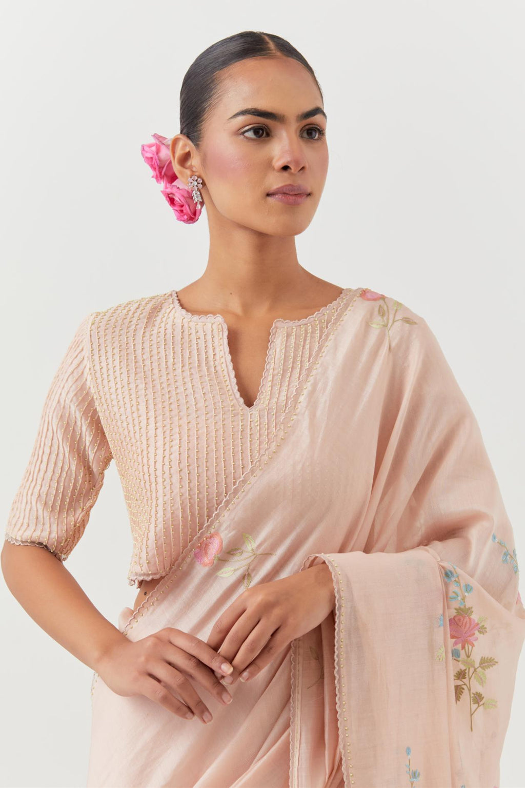 Pink silk chanderi blouse with pin tucks, highlighted with bead work.