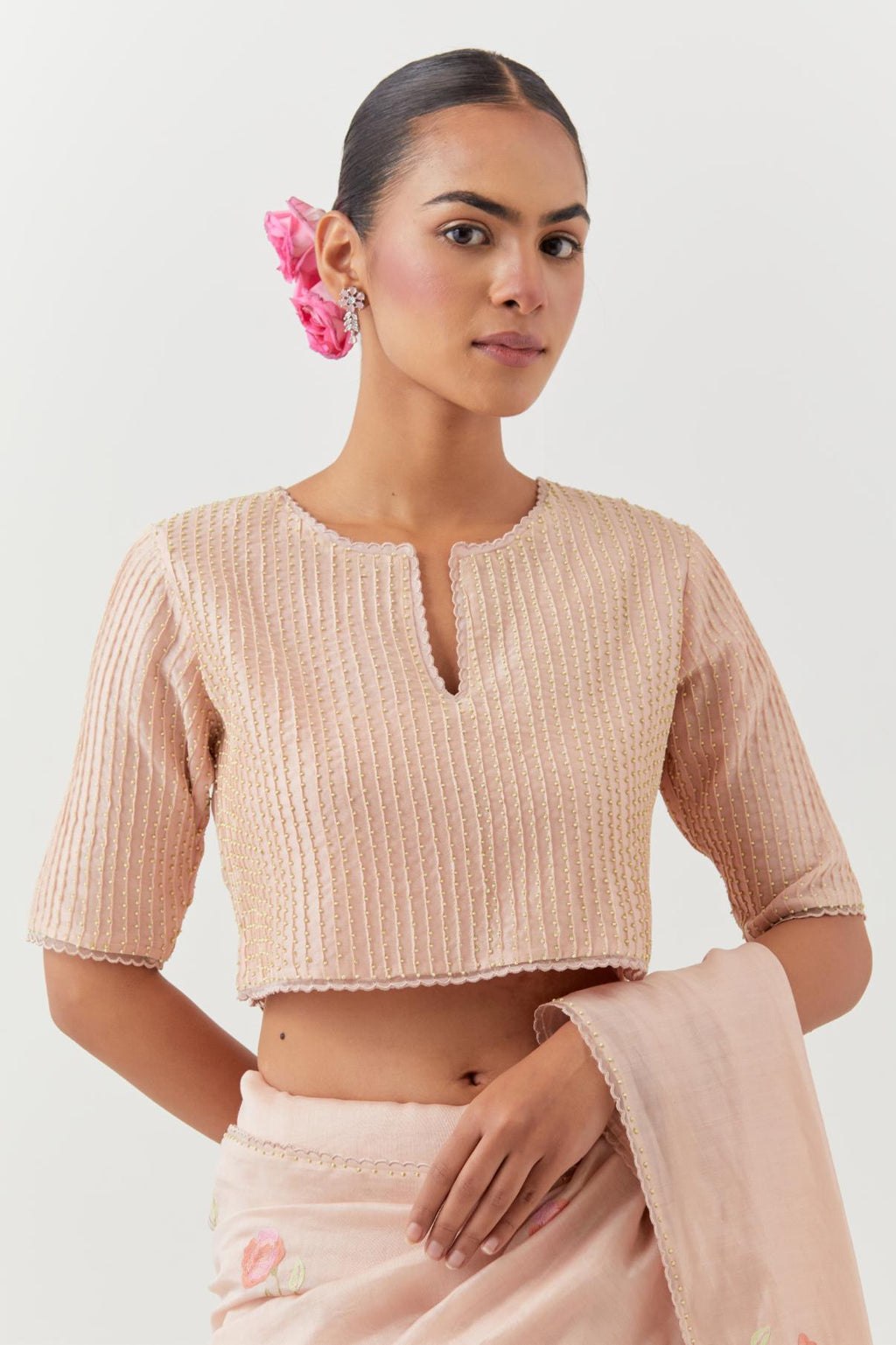 Pink silk chanderi blouse with pin tucks, highlighted with bead work.