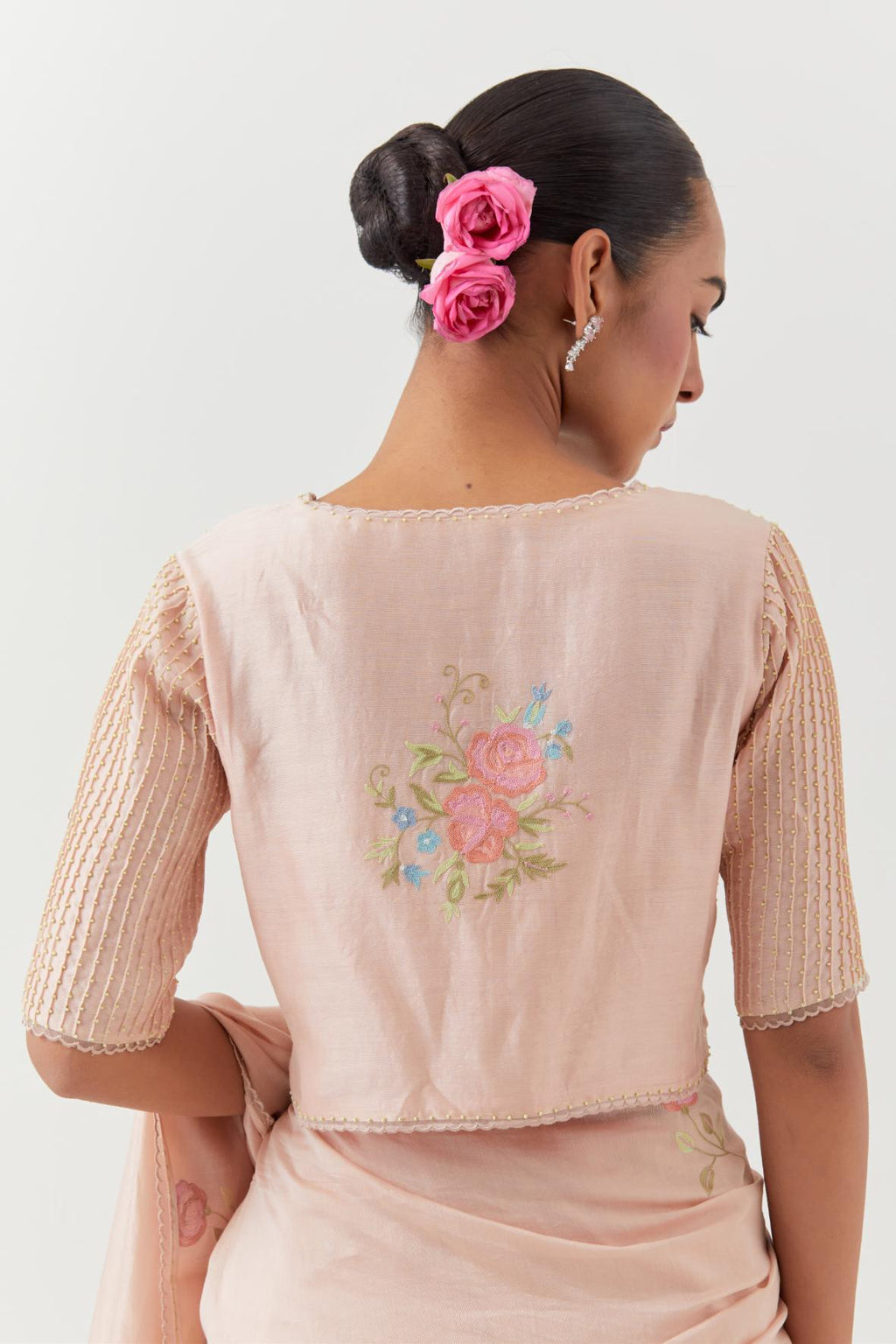 Pink silk chanderi blouse with pin tucks, highlighted with bead work.