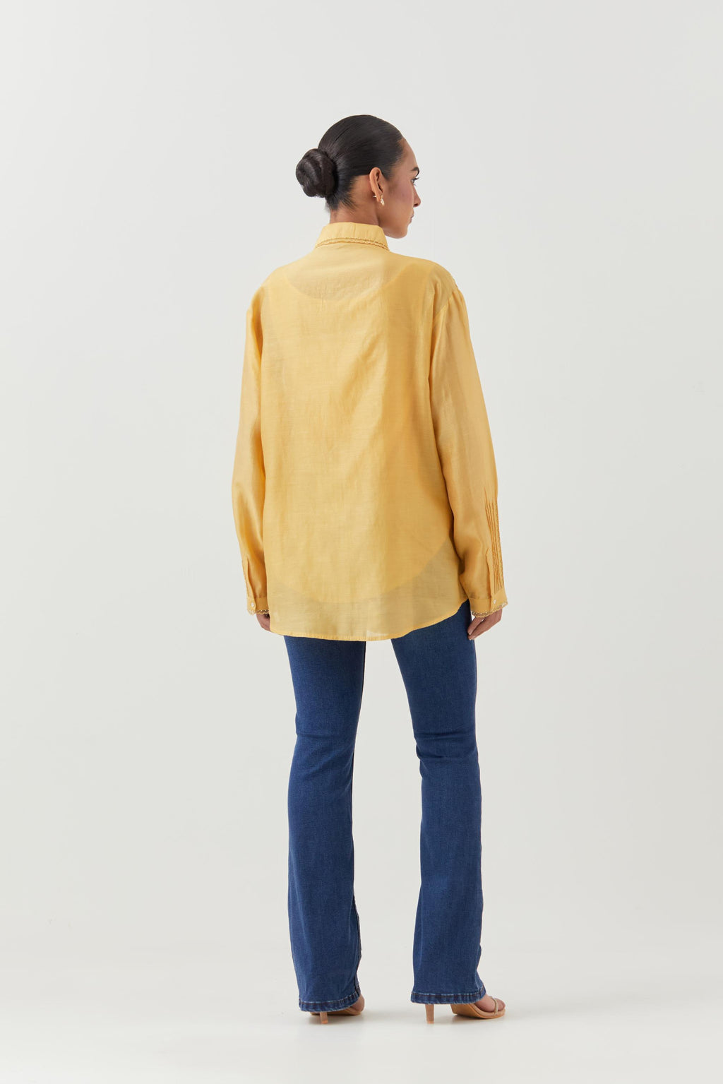 Yellow silk chanderi shirt with all-over pin tucks, highlighted with contrast beads in the front.