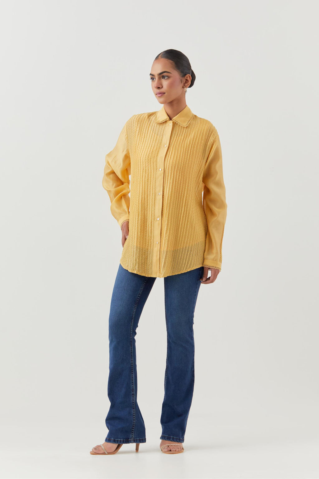 Yellow silk chanderi shirt with all-over pin tucks, highlighted with contrast beads in the front.