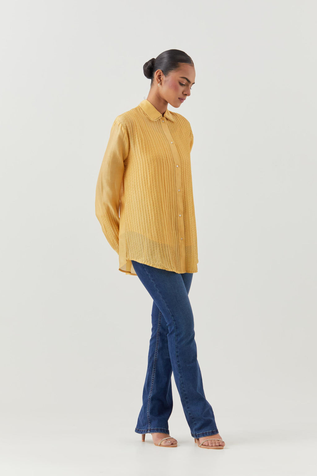 Yellow silk chanderi shirt with all-over pin tucks, highlighted with contrast beads in the front.