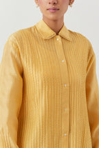 Yellow silk chanderi shirt with all-over pin tucks, highlighted with contrast beads in the front.