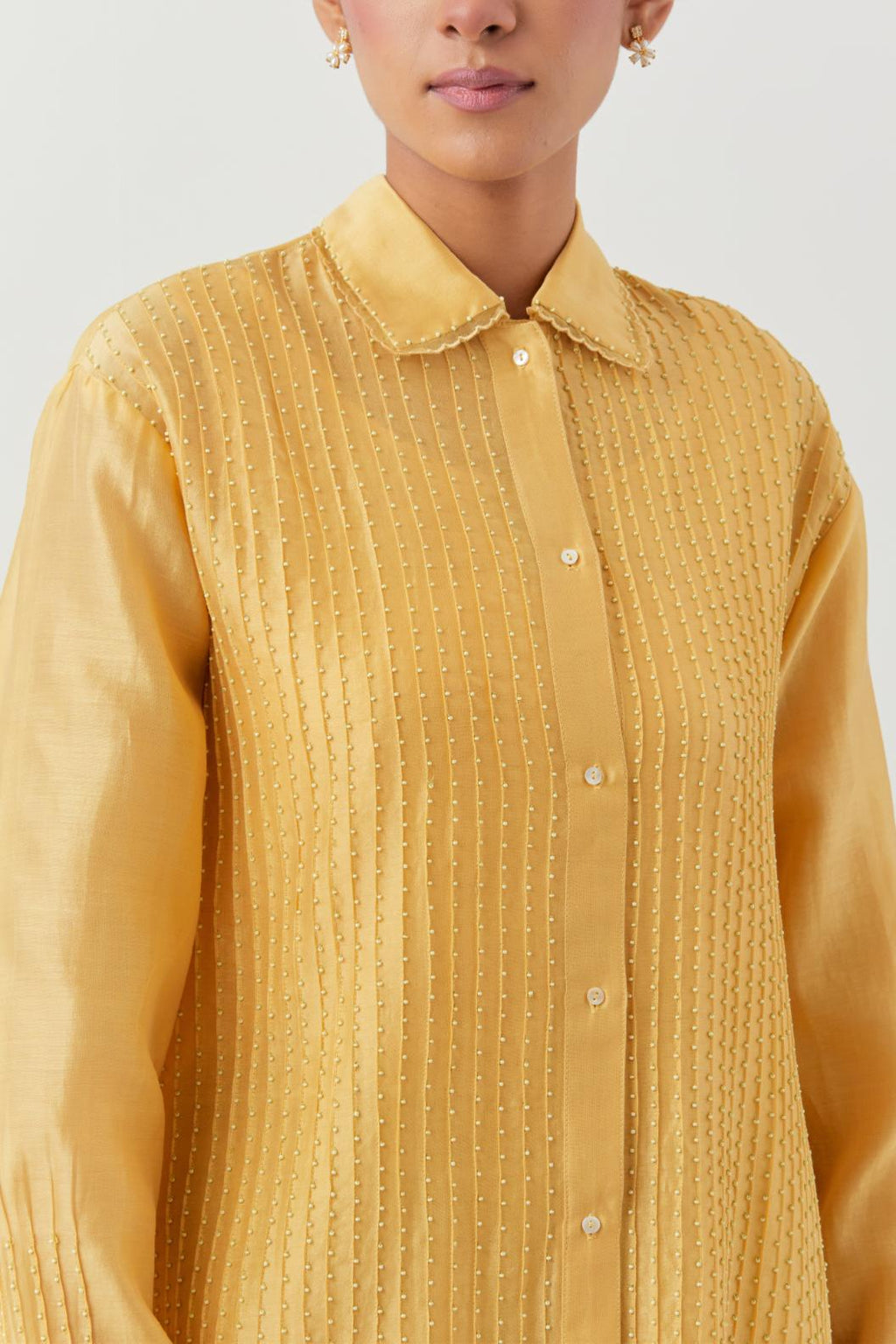 Yellow silk chanderi shirt with all-over pin tucks, highlighted with contrast beads in the front.