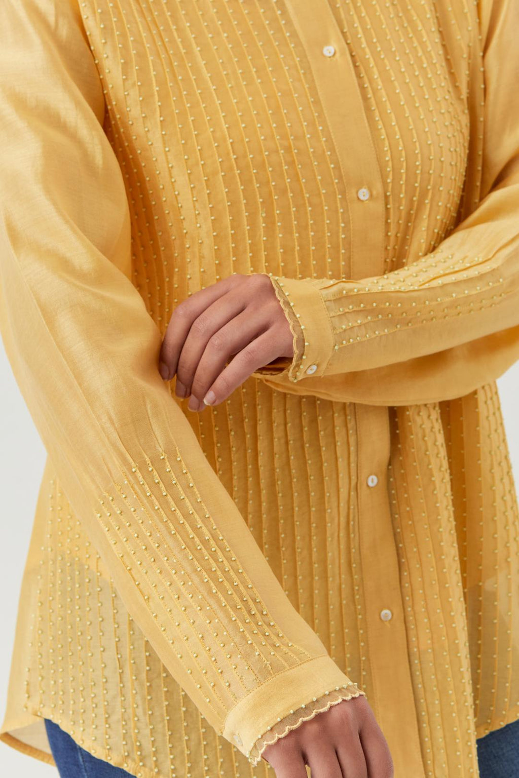 Yellow silk chanderi shirt with all-over pin tucks, highlighted with contrast beads in the front.