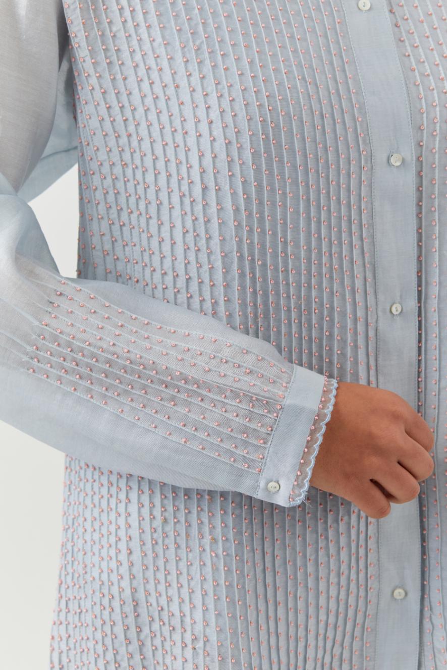 Blue silk chanderi shirt with all-over pin tucks, highlighted with contrast beads in the front.