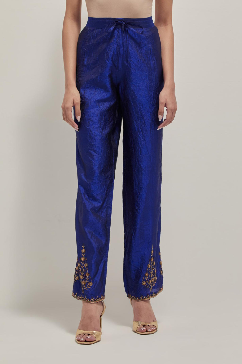 Blue Silk pants, highlighted with hand embroidered bead, sequins and zardozi boota at hem, highlighted with contrast bead work.