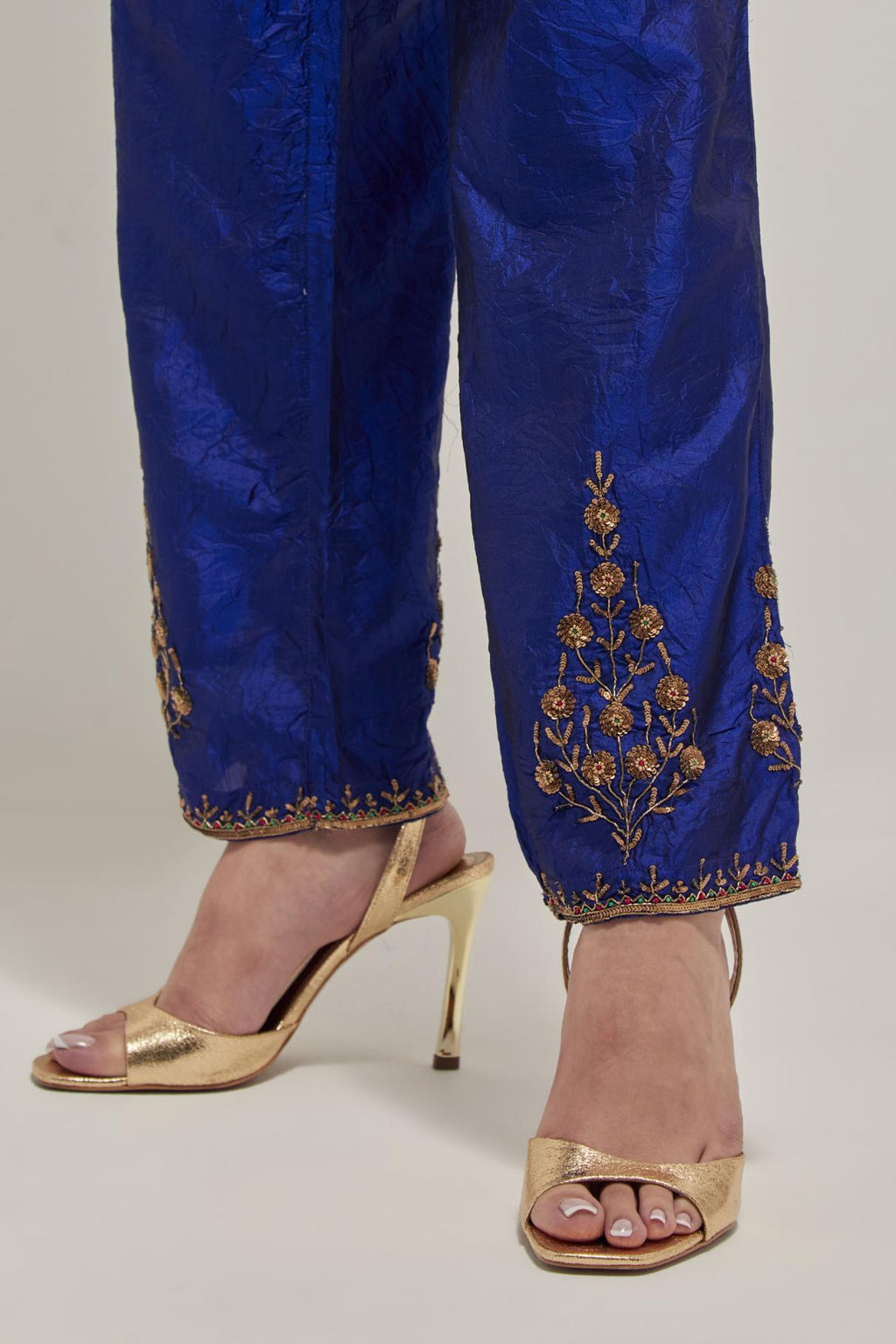 Blue Silk pants, highlighted with hand embroidered bead, sequins and zardozi boota at hem, highlighted with contrast bead work.