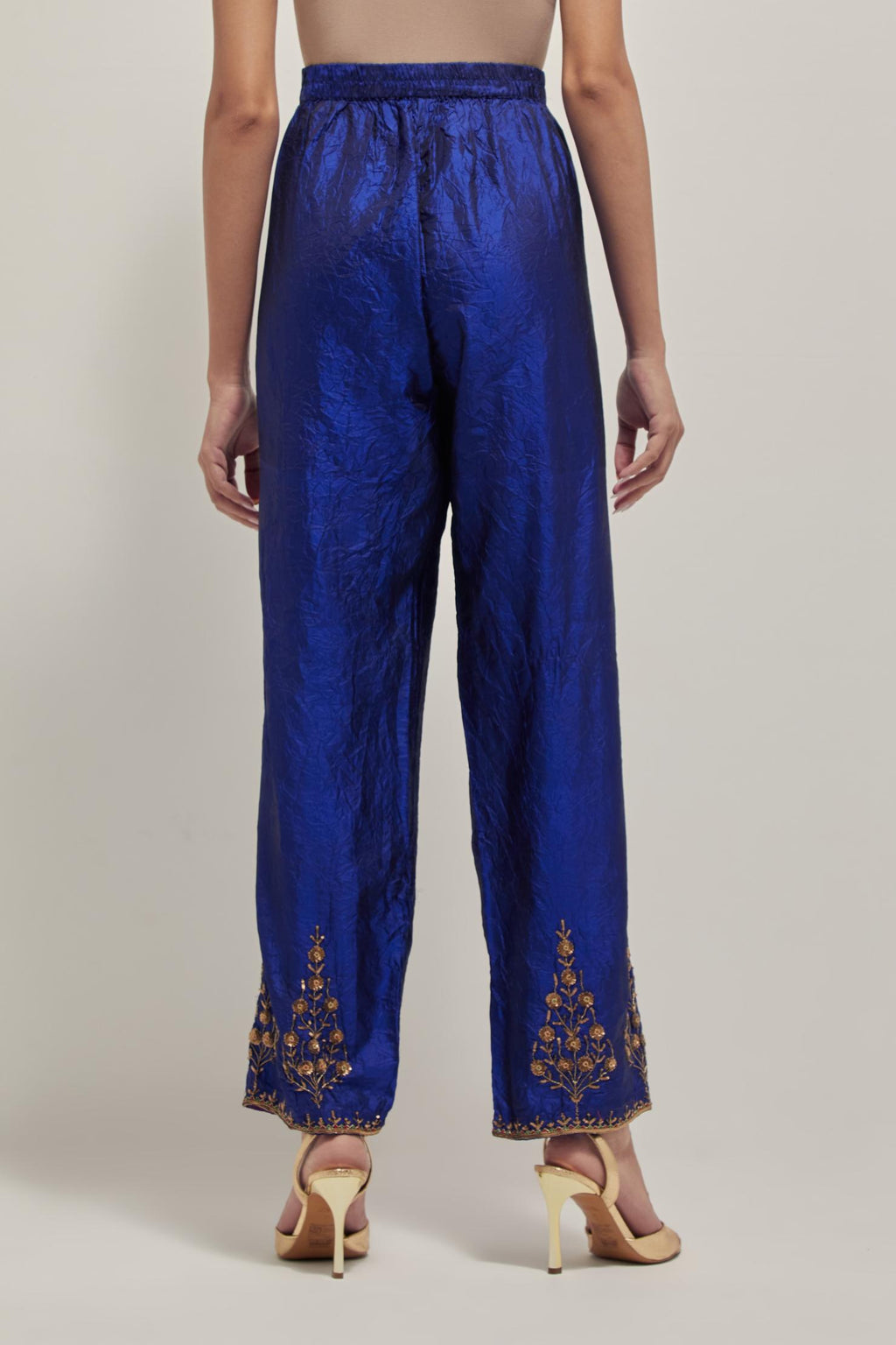 Blue Silk pants, highlighted with hand embroidered bead, sequins and zardozi boota at hem, highlighted with contrast bead work.
