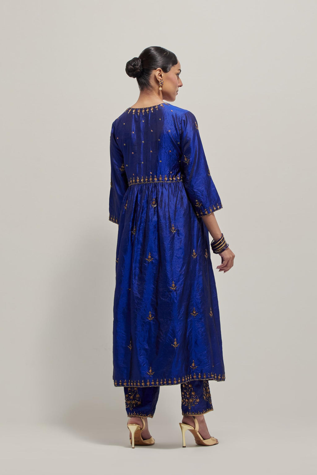 Blue double toned silk kurta set with hand embroidered zardozi and sequins, highlighted with beads.