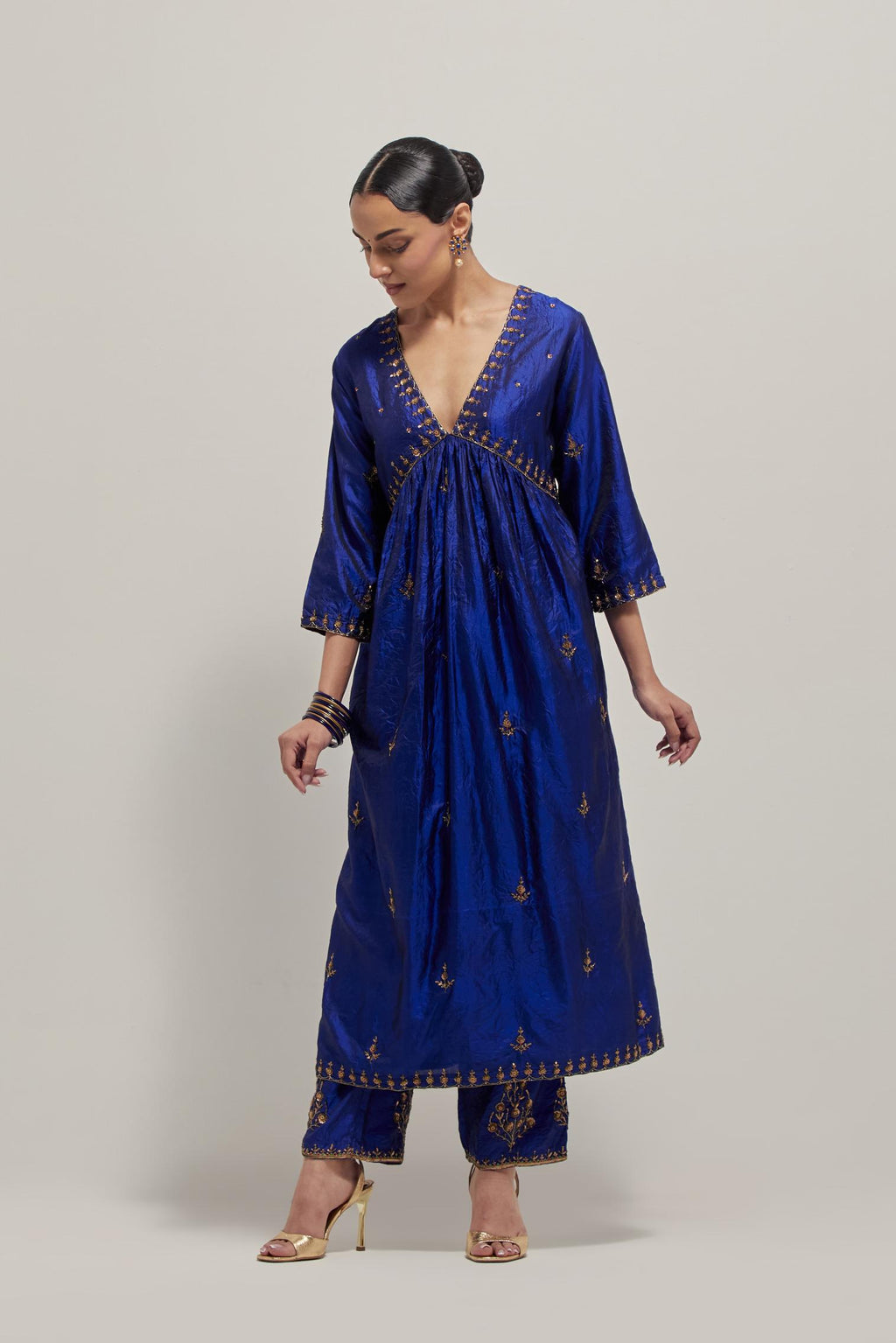 Blue double toned silk kurta set with hand embroidered zardozi and sequins, highlighted with beads.