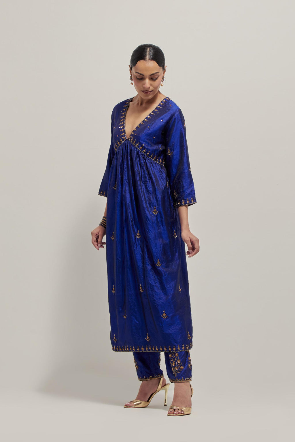 Blue double toned silk kurta set with hand embroidered zardozi and sequins, highlighted with beads.