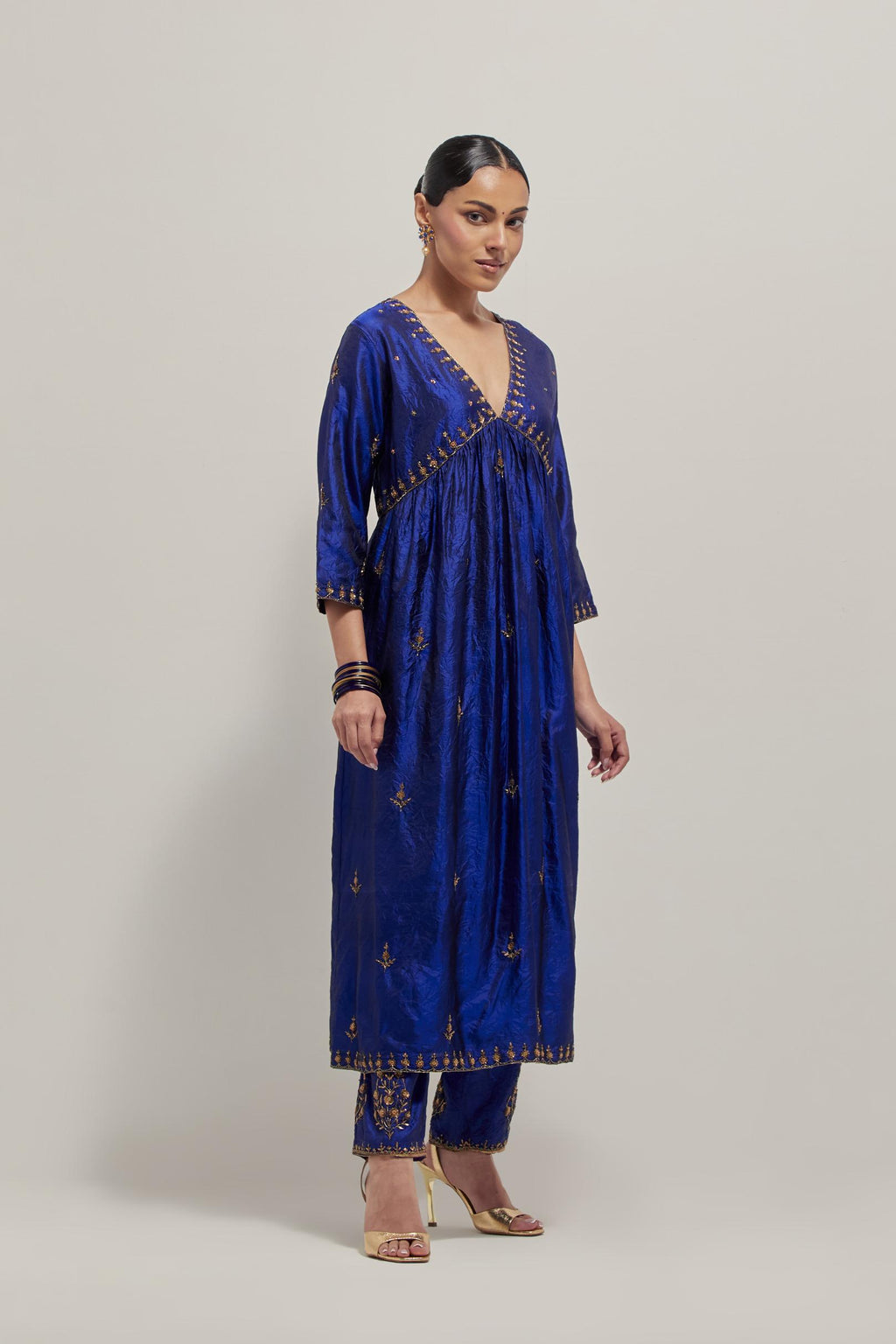 Blue double toned silk kurta set with hand embroidered zardozi and sequins, highlighted with beads.