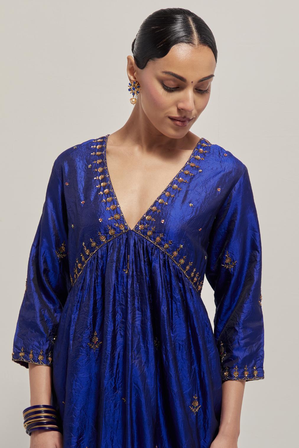 Blue double toned silk kurta set with hand embroidered zardozi and sequins, highlighted with beads.