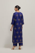 Blue silk straight kurta set with all-over hand embroidered sequins on bandhani inspired motifs, highlighted with contrast-colored beads.