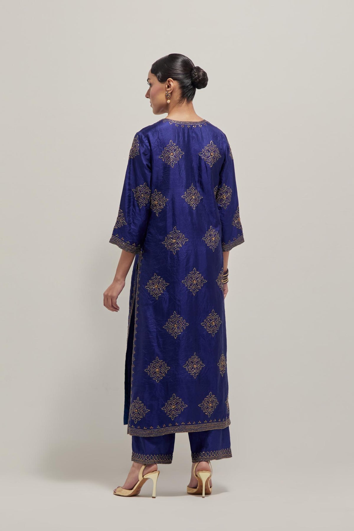 Blue silk straight kurta set with all-over hand embroidered sequins on bandhani inspired motifs, highlighted with contrast-colored beads.