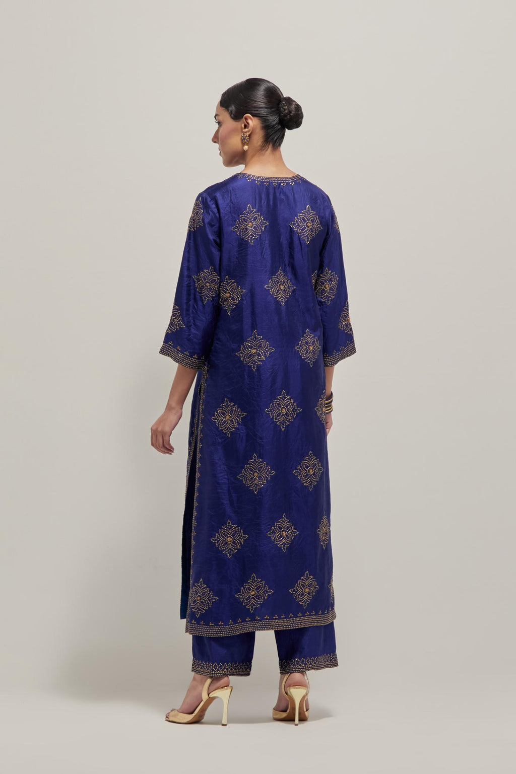 Blue silk straight kurta set with all-over hand embroidered sequins on bandhani inspired motifs, highlighted with contrast-colored beads.