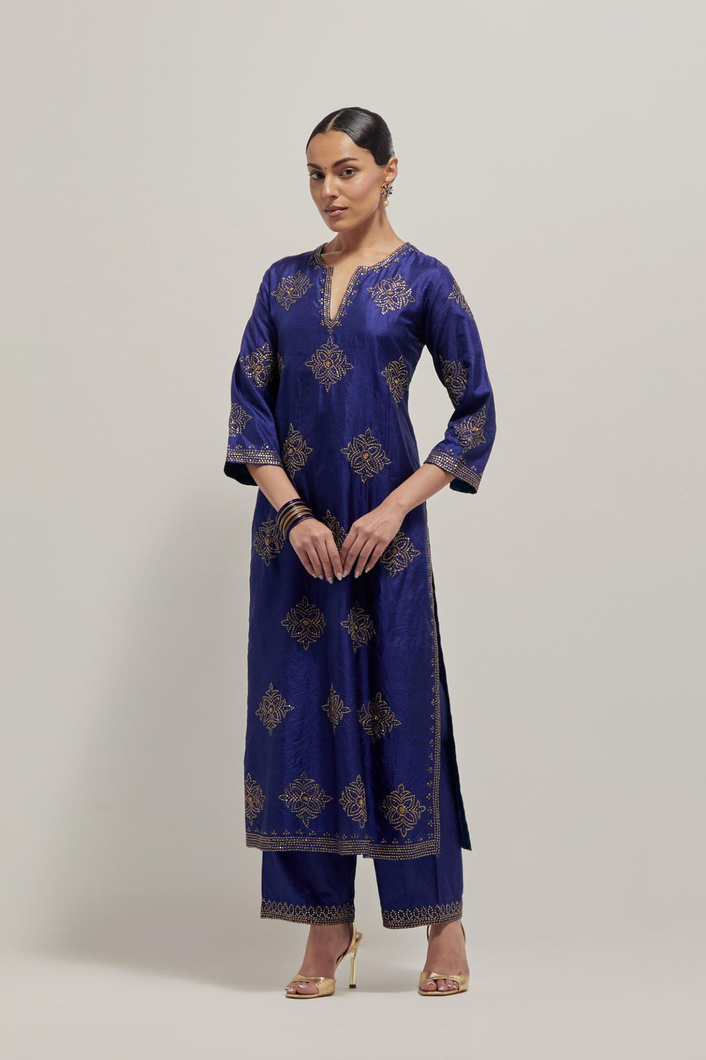 Blue silk straight kurta set with all-over hand embroidered sequins on bandhani inspired motifs, highlighted with contrast-colored beads.