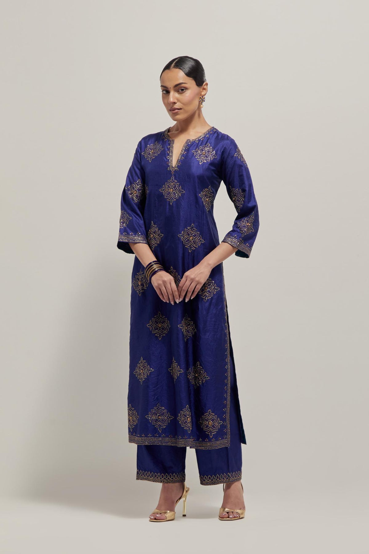 Blue silk straight kurta set with all-over hand embroidered sequins on bandhani inspired motifs, highlighted with contrast-colored beads.