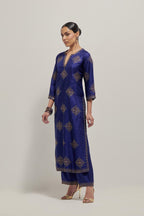 Blue silk straight kurta set with all-over hand embroidered sequins on bandhani inspired motifs, highlighted with contrast-colored beads.