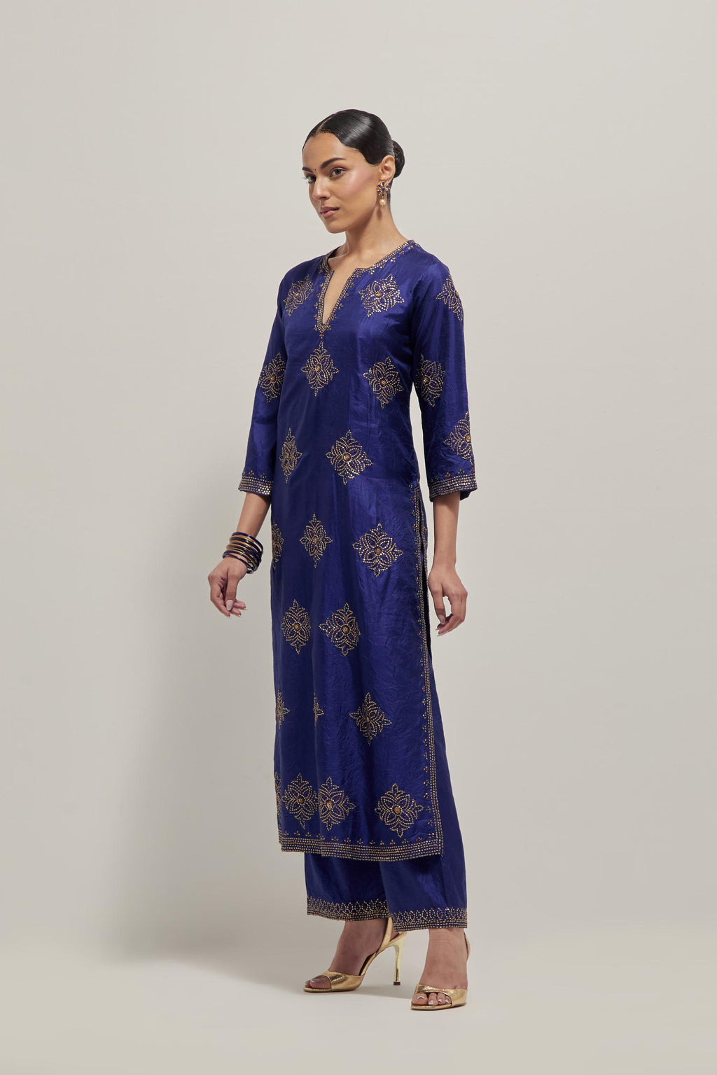 Blue silk straight kurta set with all-over hand embroidered sequins on bandhani inspired motifs, highlighted with contrast-colored beads.