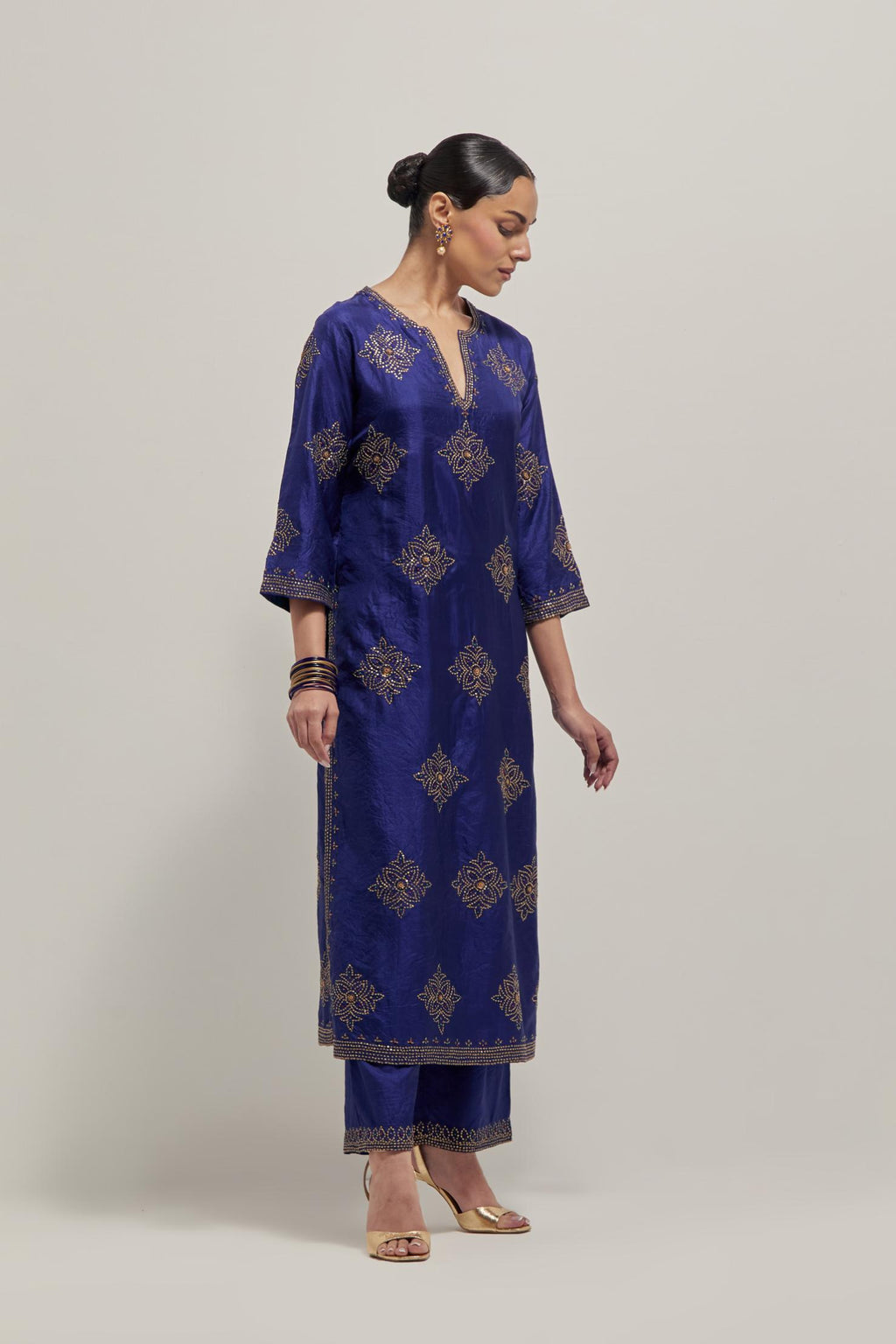 Blue silk straight kurta set with all-over hand embroidered sequins on bandhani inspired motifs, highlighted with contrast-colored beads.