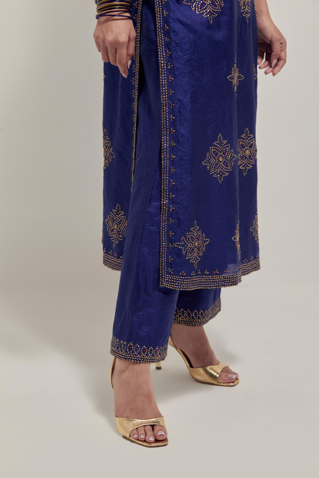 Blue silk straight kurta set with all-over hand embroidered sequins on bandhani inspired motifs, highlighted with contrast-colored beads.