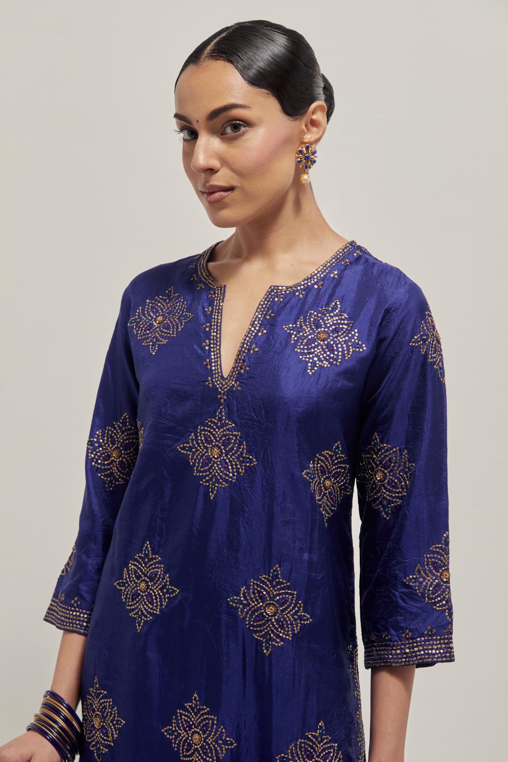Blue silk straight kurta set with all-over hand embroidered sequins on bandhani inspired motifs, highlighted with contrast-colored beads.