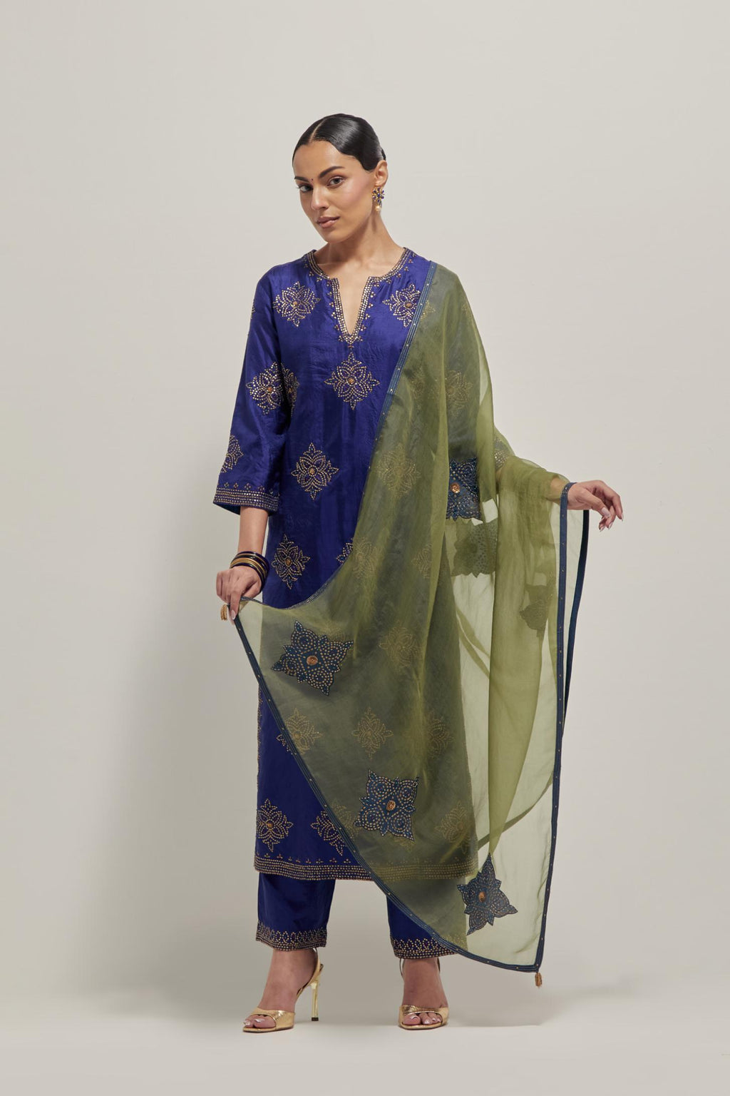 Blue silk straight kurta set with all-over hand embroidered sequins on bandhani inspired motifs, highlighted with contrast-colored beads.