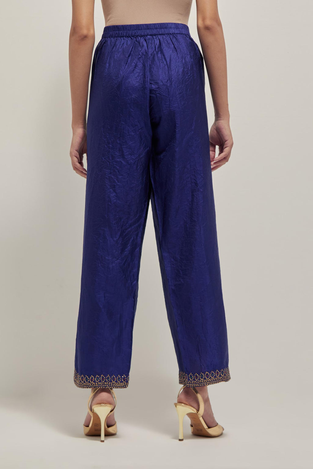 Blue silk pants with a narrow bandhani-inspired border at the hem, detailed with delicate bead and sequin work.