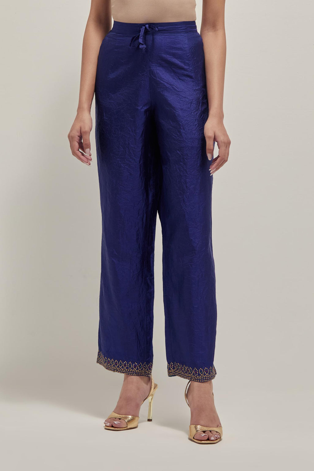 Blue silk pants with a narrow bandhani-inspired border at the hem, detailed with delicate bead and sequin work.