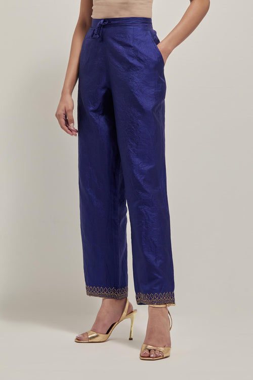 Blue silk pants with a narrow bandhani-inspired border at the hem, detailed with delicate bead and sequin work.