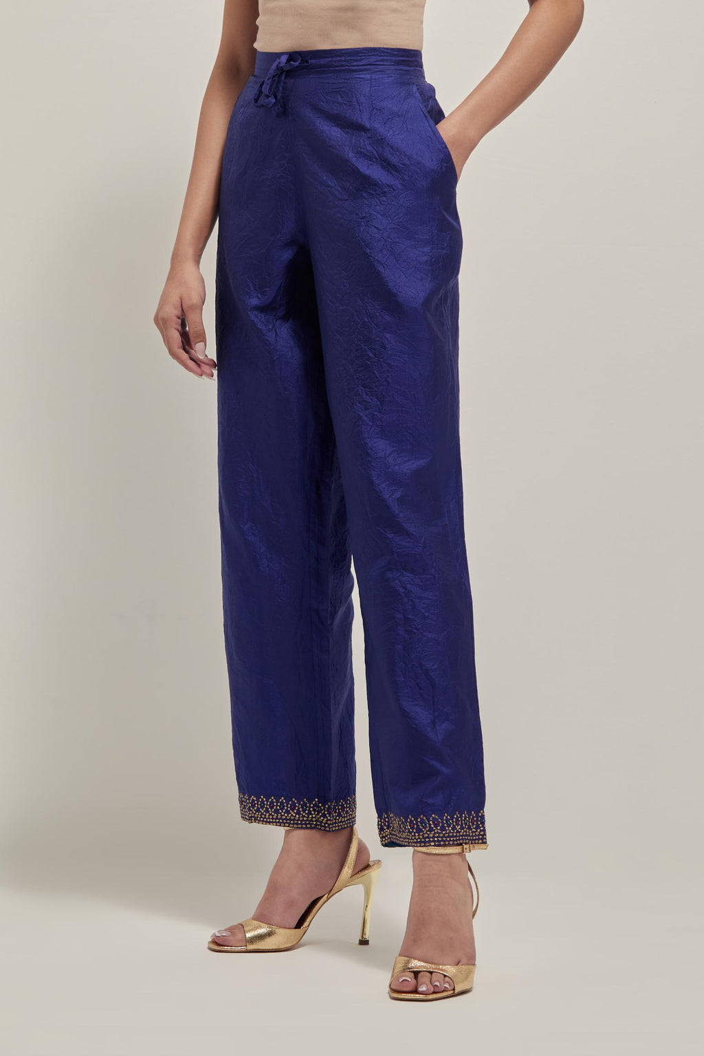 Blue silk pants with a narrow bandhani-inspired border at the hem, detailed with delicate bead and sequin work.
