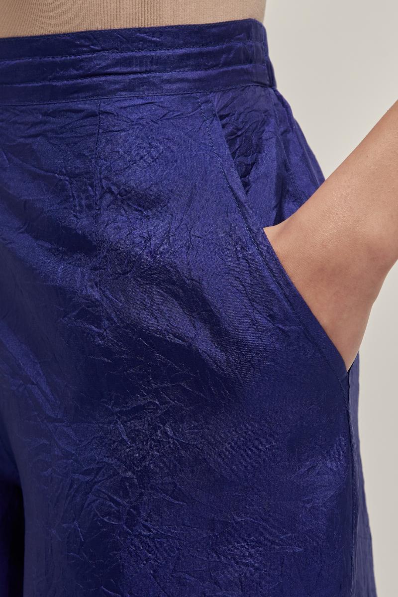 Blue silk pants with a narrow bandhani-inspired border at the hem, detailed with delicate bead and sequin work.