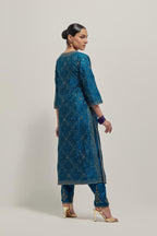 Teal silk straight kurta set with hand embroidered sequins on bandhani inspired jaal all-over the kurta, highlighted with contrast-colored beads.