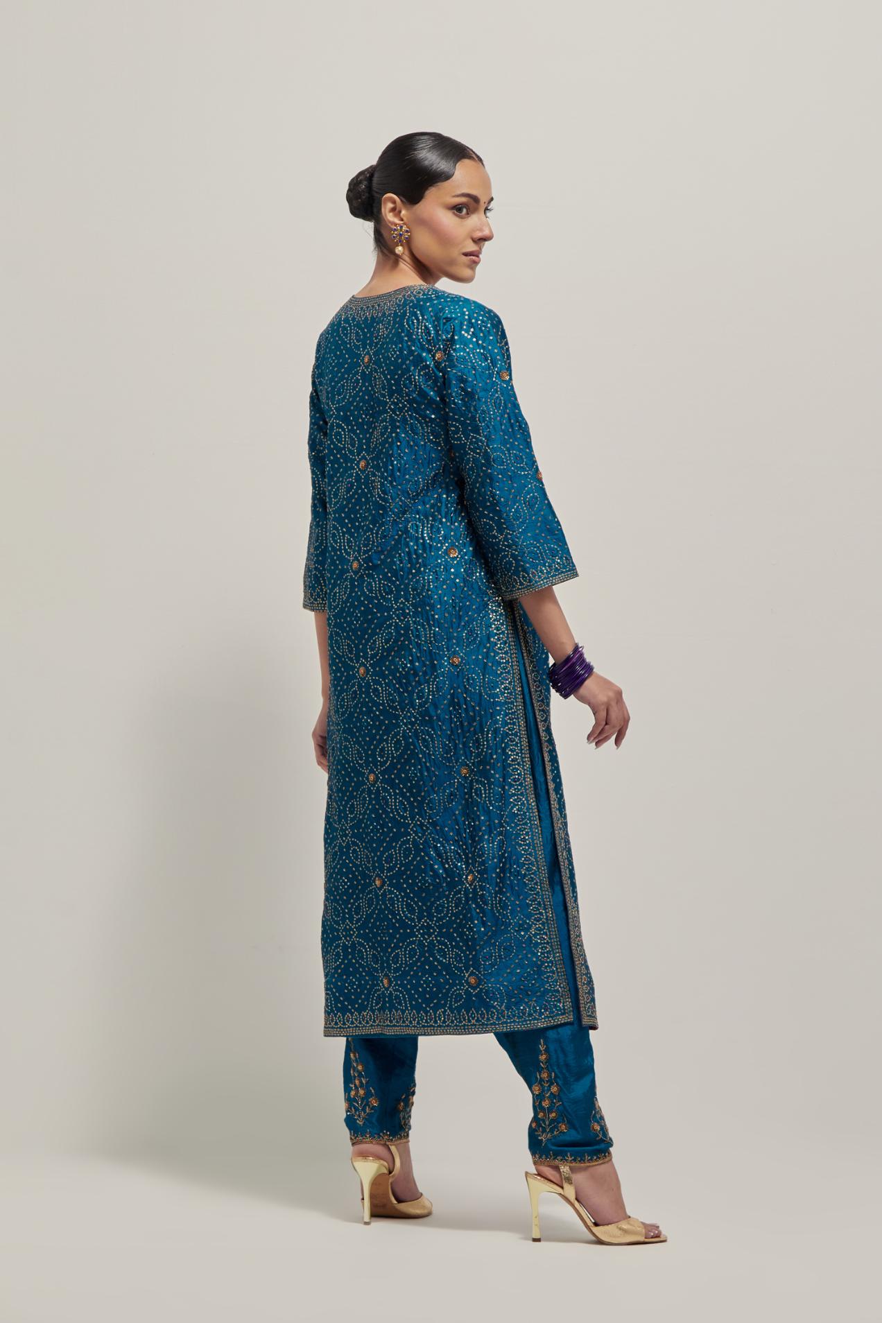 Teal silk straight kurta set with hand embroidered sequins on bandhani inspired jaal all-over the kurta, highlighted with contrast-colored beads.