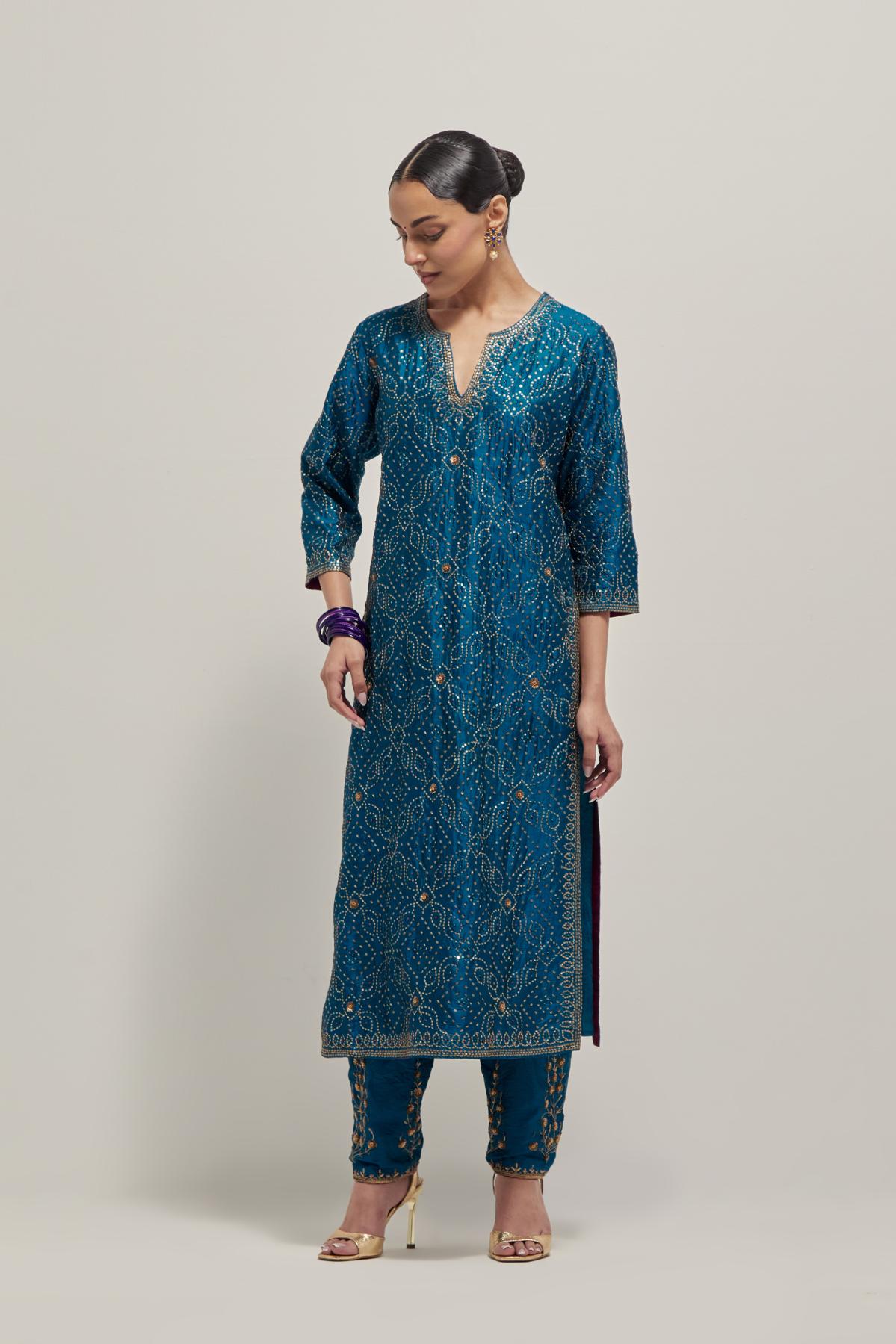 Teal silk straight kurta set with hand embroidered sequins on bandhani inspired jaal all-over the kurta, highlighted with contrast-colored beads.