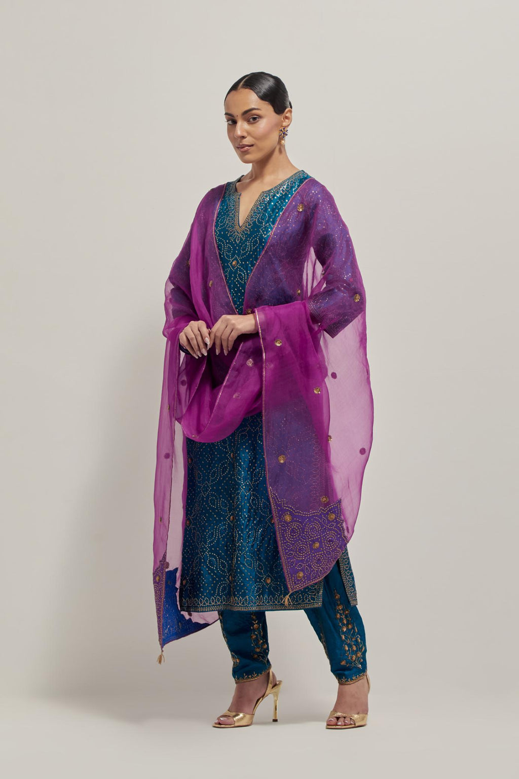 Teal silk straight kurta set with hand embroidered sequins on bandhani inspired jaal all-over the kurta, highlighted with contrast-colored beads.