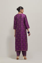 Purple silk straight kurta set with hand embroidered sequins on bandhani inspired floral jaal all-over the kurta, highlighted with contrast-colored beads.