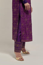 Purple silk straight kurta set with hand embroidered sequins on bandhani inspired floral jaal all-over the kurta, highlighted with contrast-colored beads.