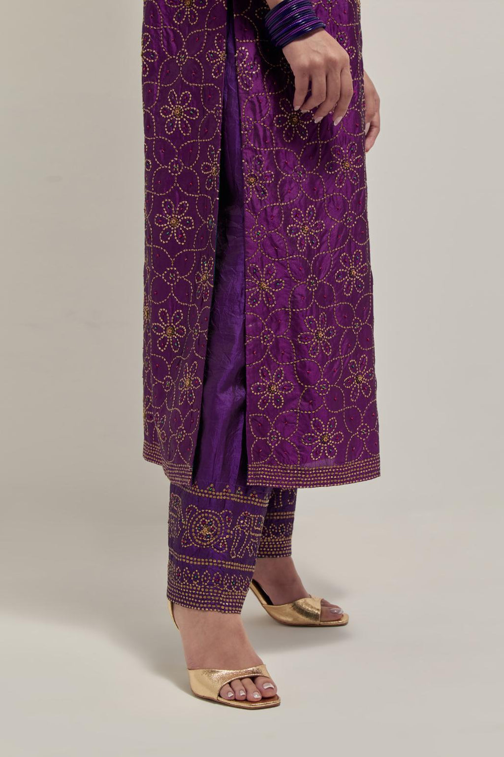 Purple silk straight kurta set with hand embroidered sequins on bandhani inspired floral jaal all-over the kurta, highlighted with contrast-colored beads.