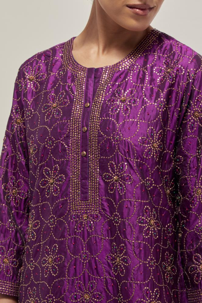 Purple silk straight kurta set with hand embroidered sequins on bandhani inspired floral jaal all-over the kurta, highlighted with contrast-colored beads.