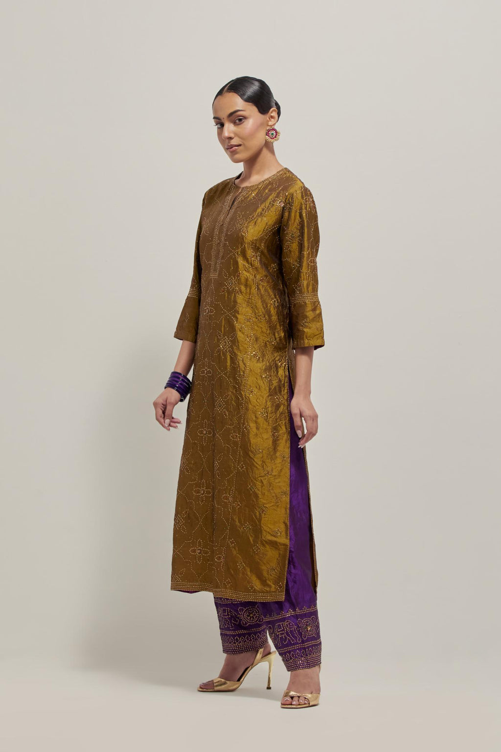 Olive Silk kurta set with all-over hand embroidered sequins on bandhani inspired floral jaal and small square booti at side panels, highlighted with contrast-colored beads.