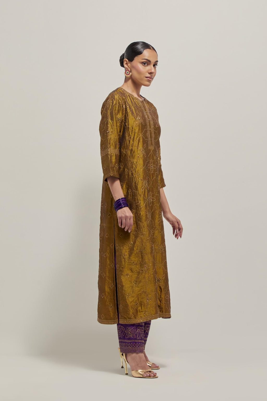 Olive Silk kurta set with all-over hand embroidered sequins on bandhani inspired floral jaal and small square booti at side panels, highlighted with contrast-colored beads.