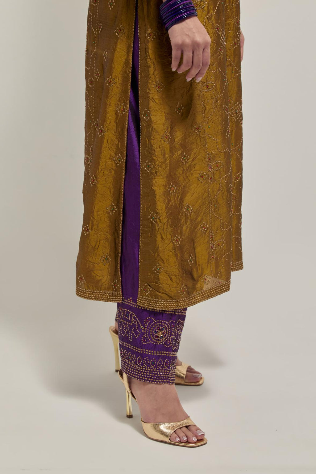 Olive Silk kurta set with all-over hand embroidered sequins on bandhani inspired floral jaal and small square booti at side panels, highlighted with contrast-colored beads.